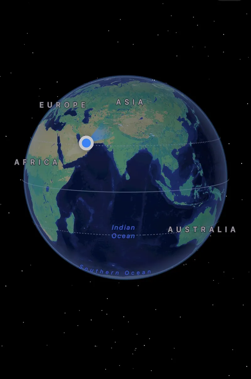 Apple Maps satellite view zoomed out to a globe, showing stars in the skybox behind Earth