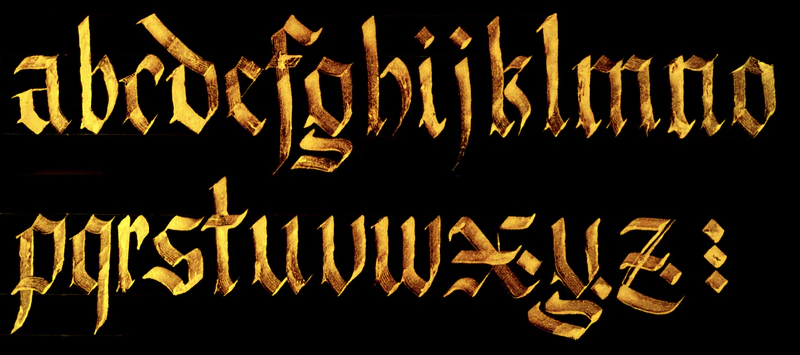 The alphabet in Gothic Fraktur, gold ink on black paper